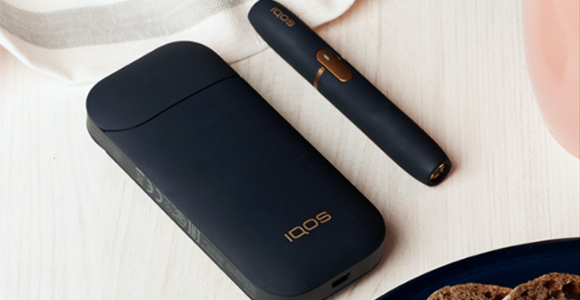 Black IQOS 2.4 PLUS kit on a table