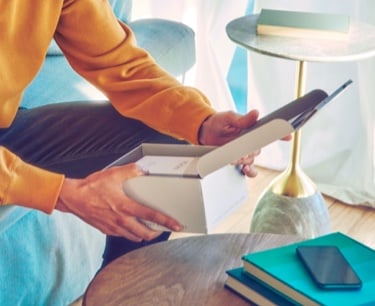 Close up of man's hands unboxing a new IQOS device